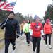 Chelsea resident Judy Gentz, center, walks with Air Force officer Chris Aguillera toward the grave site of Judy's son, Joel, who was killed in the same helicopter rescue mission crash which Chris survived, injured. Judy started Team Red White and Blue to run and organize community events to show support for troops, and the flag they carry has been used on rescue missions in Afghanistan. Angela J. Cesere | AnnArbor.com 